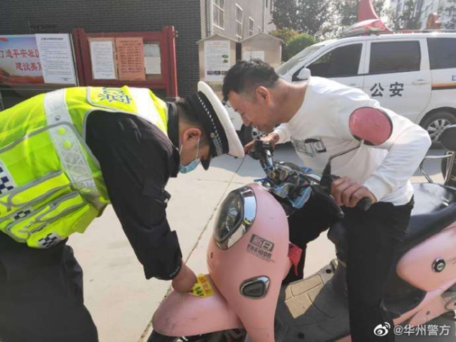 华州公安交管大队民警手拿宣传资料走进集市进行交通宣传。