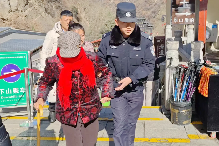 华阴公安护送年纪较大的老人下山。