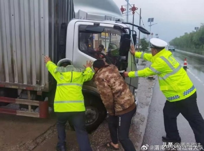 临渭民警雨天救助被困货车。