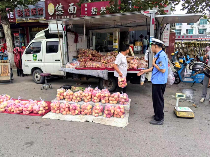 韩城市公安局交警大队对影响道路通行的占道摊贩进行清理劝导。